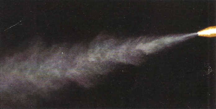 Conventional coolant mister producing a cloud of atomized fog